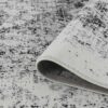 Close-up of textured gray and white rug.