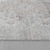 Close-up of textured gray and white rug on floor.