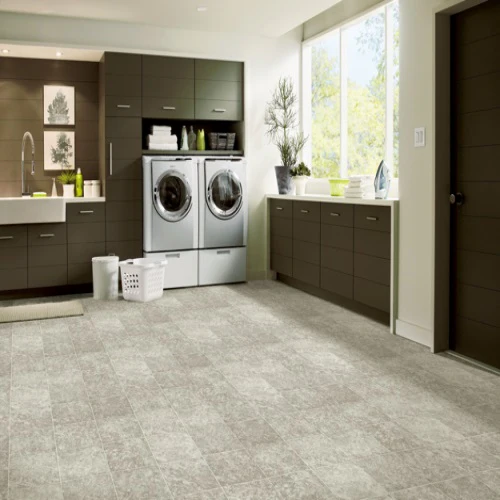 Modern laundry room with washers and cabinets.