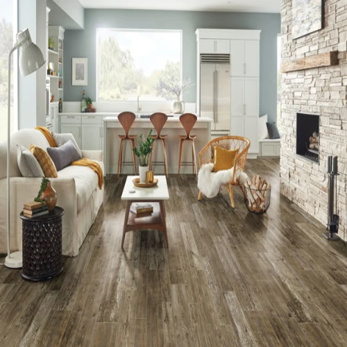 Modern open kitchen and living room with wood flooring.