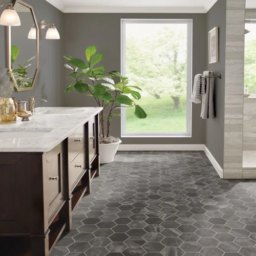 Modern bathroom with hexagonal tiles and large window.