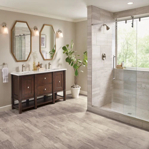 Modern bathroom with glass shower and double vanity.