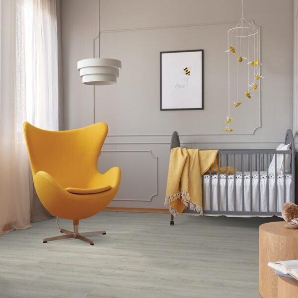 Modern nursery with yellow chair and crib.