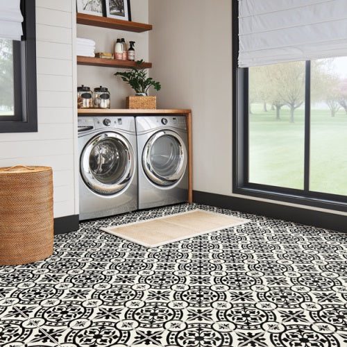 Laundry room with patterned tile flooring.