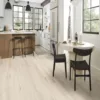 Modern kitchen with wooden flooring and white cabinets.