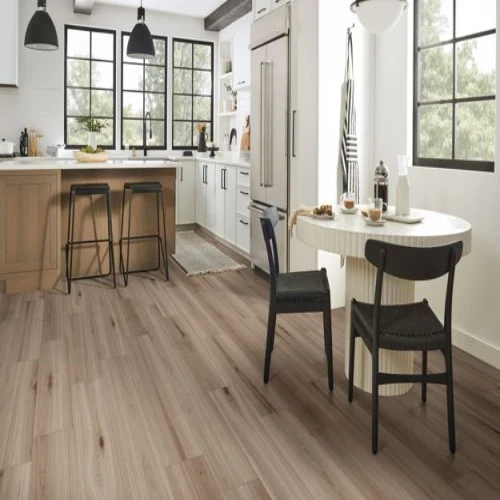 Modern kitchen with wooden flooring and dining table.