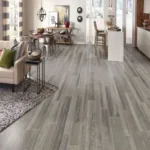 Modern open living and dining room with wood flooring.