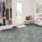 Cozy mudroom with bike and bench near doorway.