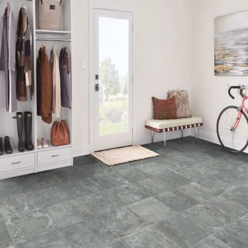 Cozy mudroom with bike and bench near doorway.