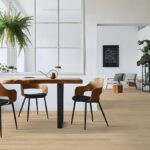 Modern dining area with wooden chairs and table.