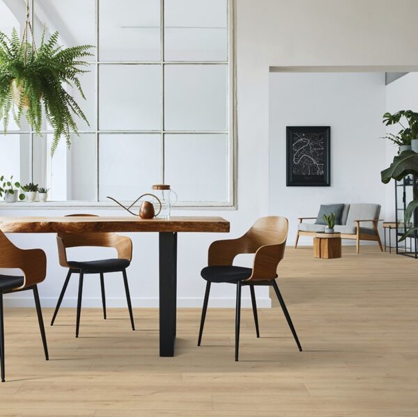 Modern dining area with wooden chairs and table.