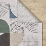 Abstract patterned rug on wooden floor