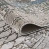 Modern textured rug with abstract pattern, corner view.