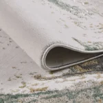 Close-up of rolled gray and green area rug