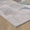 Abstract patterned rug on wooden floor.