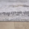 Close-up of a textured rug on wooden floor.