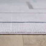 Gray rug on wooden floor close-up