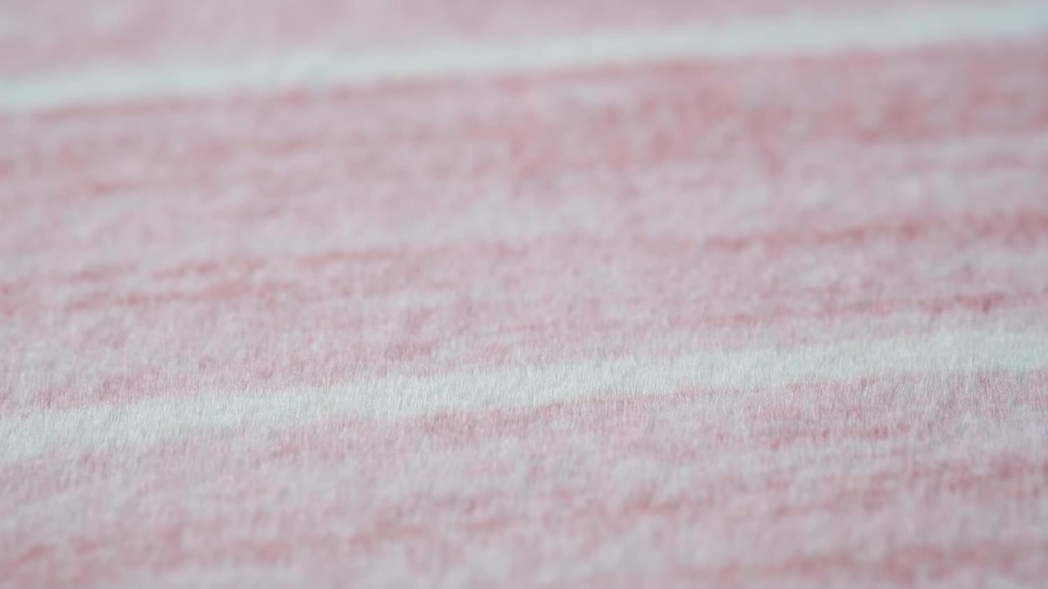 Close-up of soft pink textured fabric.