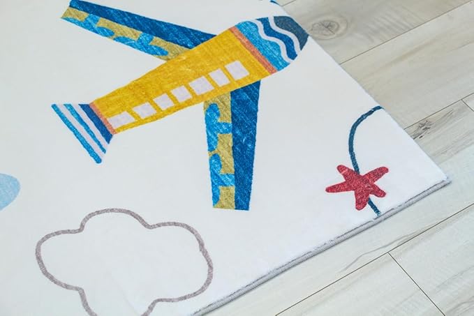 Colorful airplane design children's rug on wooden floor.
