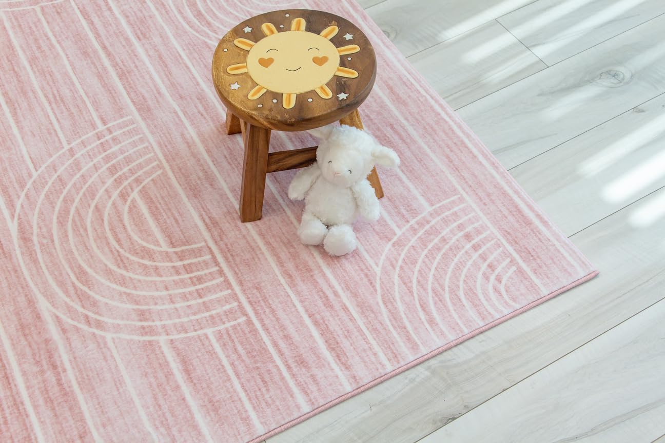 Wooden stool and plush toy on pink rug.