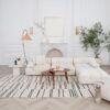Elegant living room with white couch and decor.