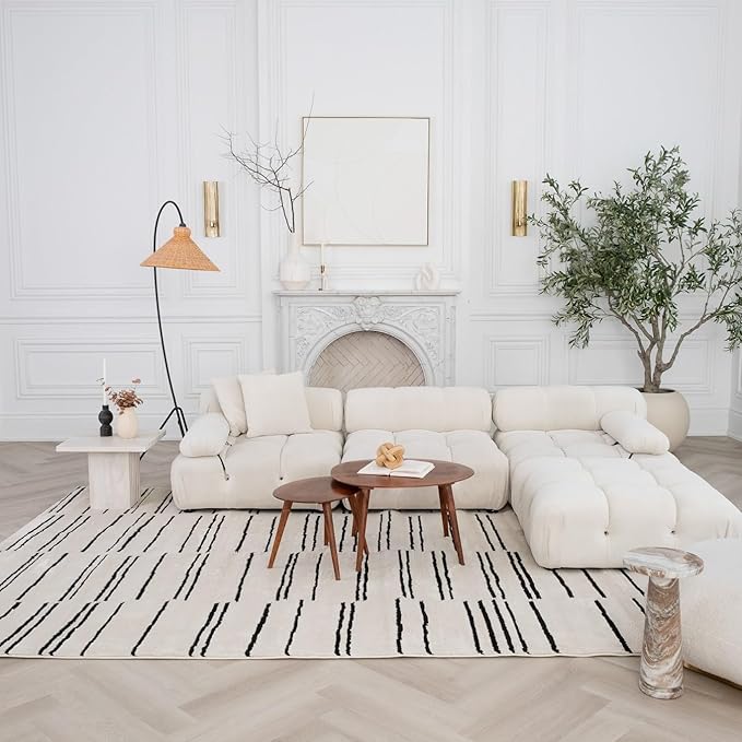 Elegant living room with white couch and decor.