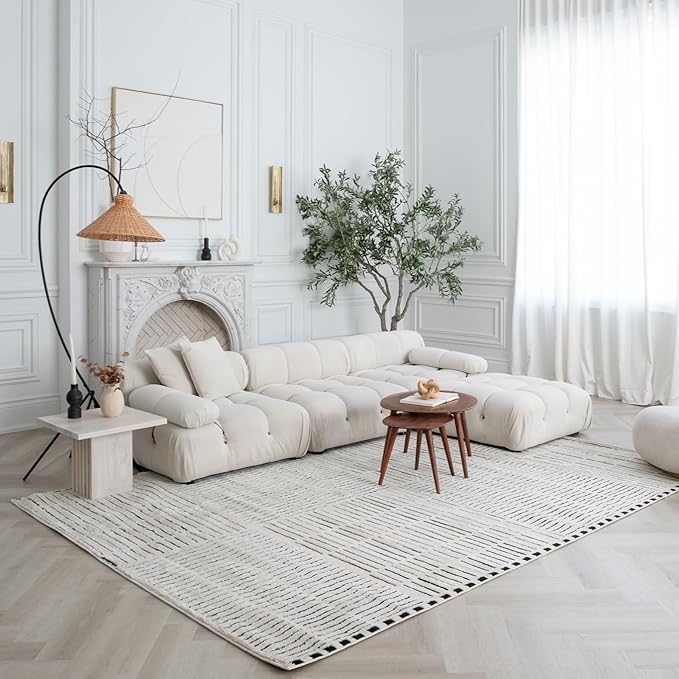 Minimalist living room with white sectional sofa.
