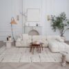 Modern living room with white sofa and plants.