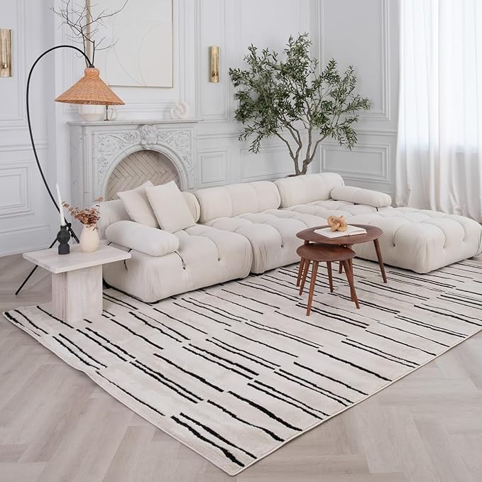 Elegant living room with white sofa and fireplace.