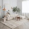 Modern living room with neutral-toned decor and furniture.