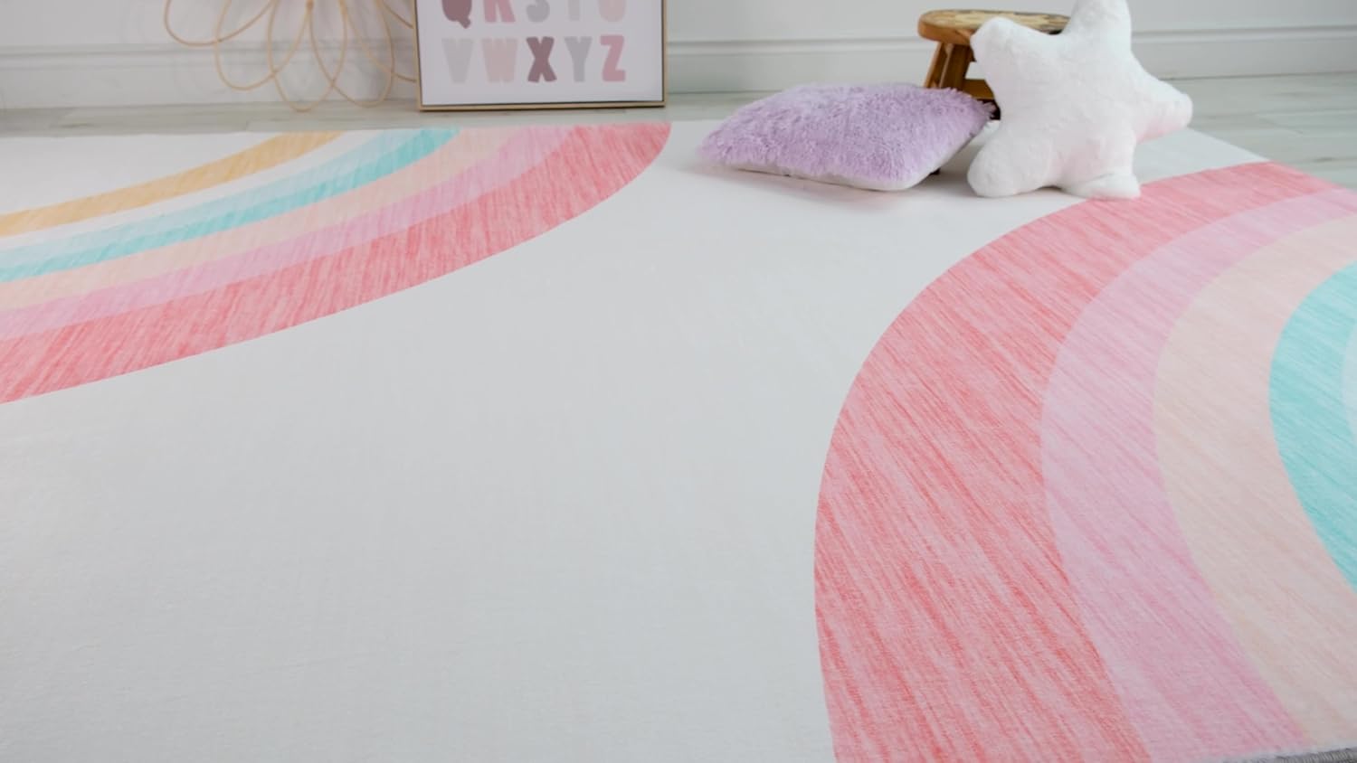 Colorful rainbow rug with pillows in children's room.