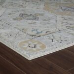 Patterned rug on dark wood floor