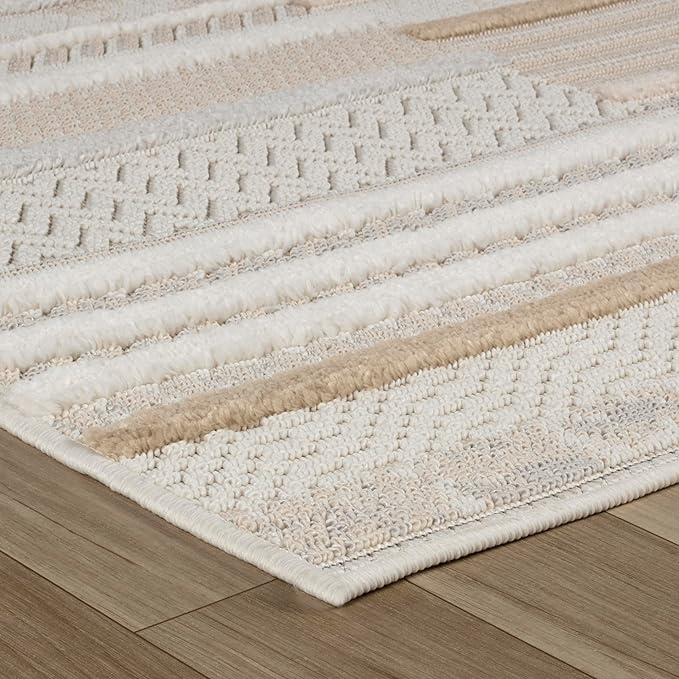 Beige and white textured area rug on wood floor.
