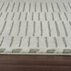Beige and green textured carpet on wooden floor