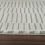 Beige and green textured carpet on wooden floor