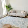 Modern living room with blue patterned rug.