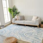 Modern living room with blue patterned rug.