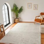 Cozy living room with armchair and large rug.