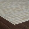 Beige striped rug on dark wood floor.