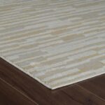 Beige striped rug on dark wood floor.