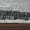 Gray rug on wooden floor texture close-up.