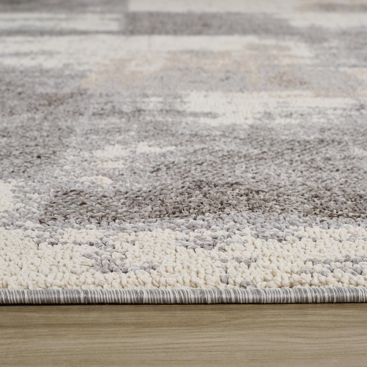 Close-up of textured gray and white area rug.