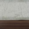 Textured beige rug on wooden floor