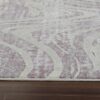 Abstract patterned rug on wooden floor.