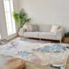 Modern living room with sofa and abstract rug.