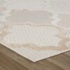 Beige geometric patterned rug on wooden floor