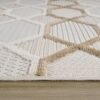 Beige and white geometric pattern rug on floor.