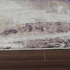 Abstract-patterned area rug on wooden floor