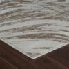 Textured beige and white rug on wooden floor.