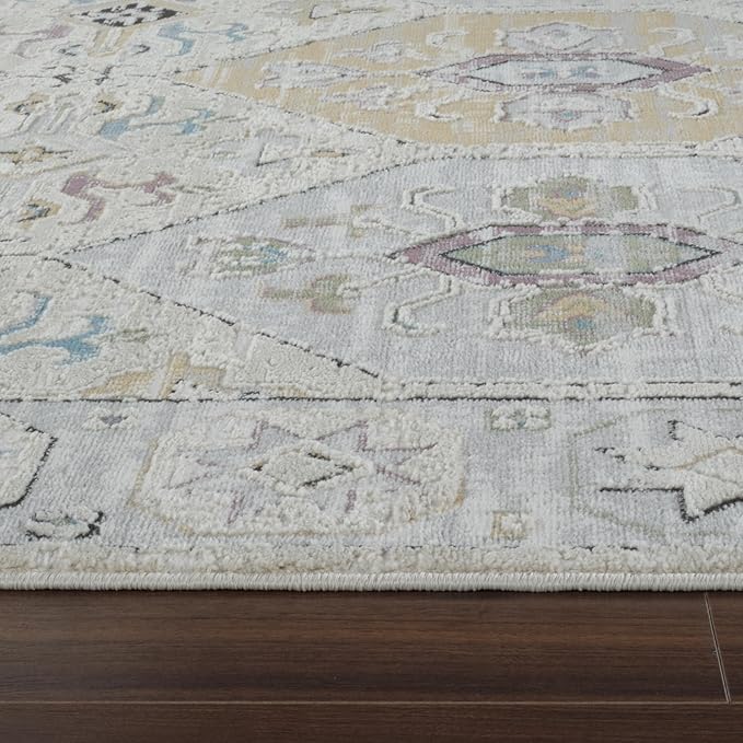 Geometric patterned area rug on wooden floor.